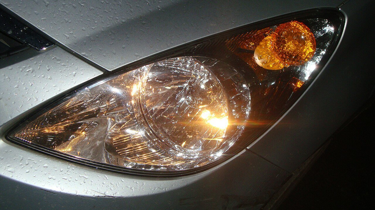 Real close-up photograph of an installed automobile headlamp