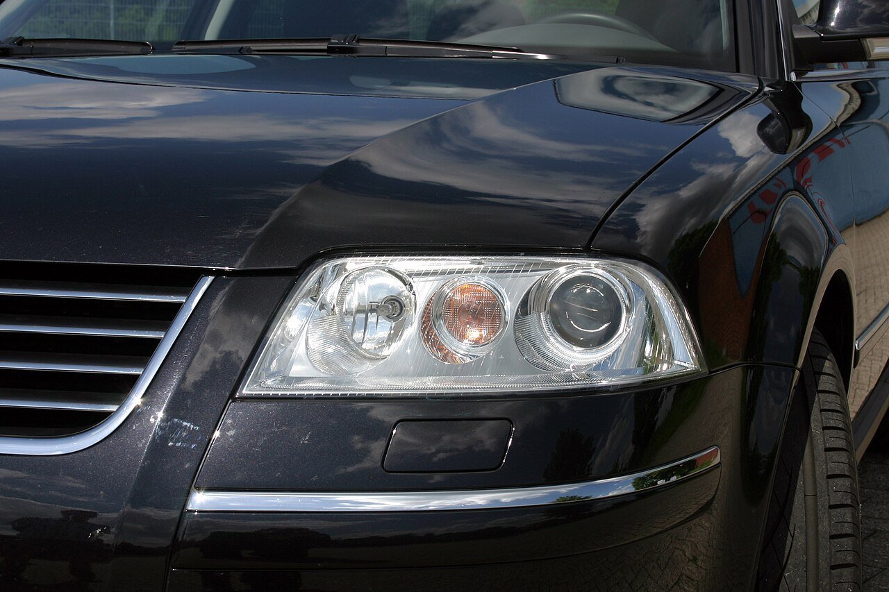 Real close-up photograph of a Volkswagen Passat headlight housing
