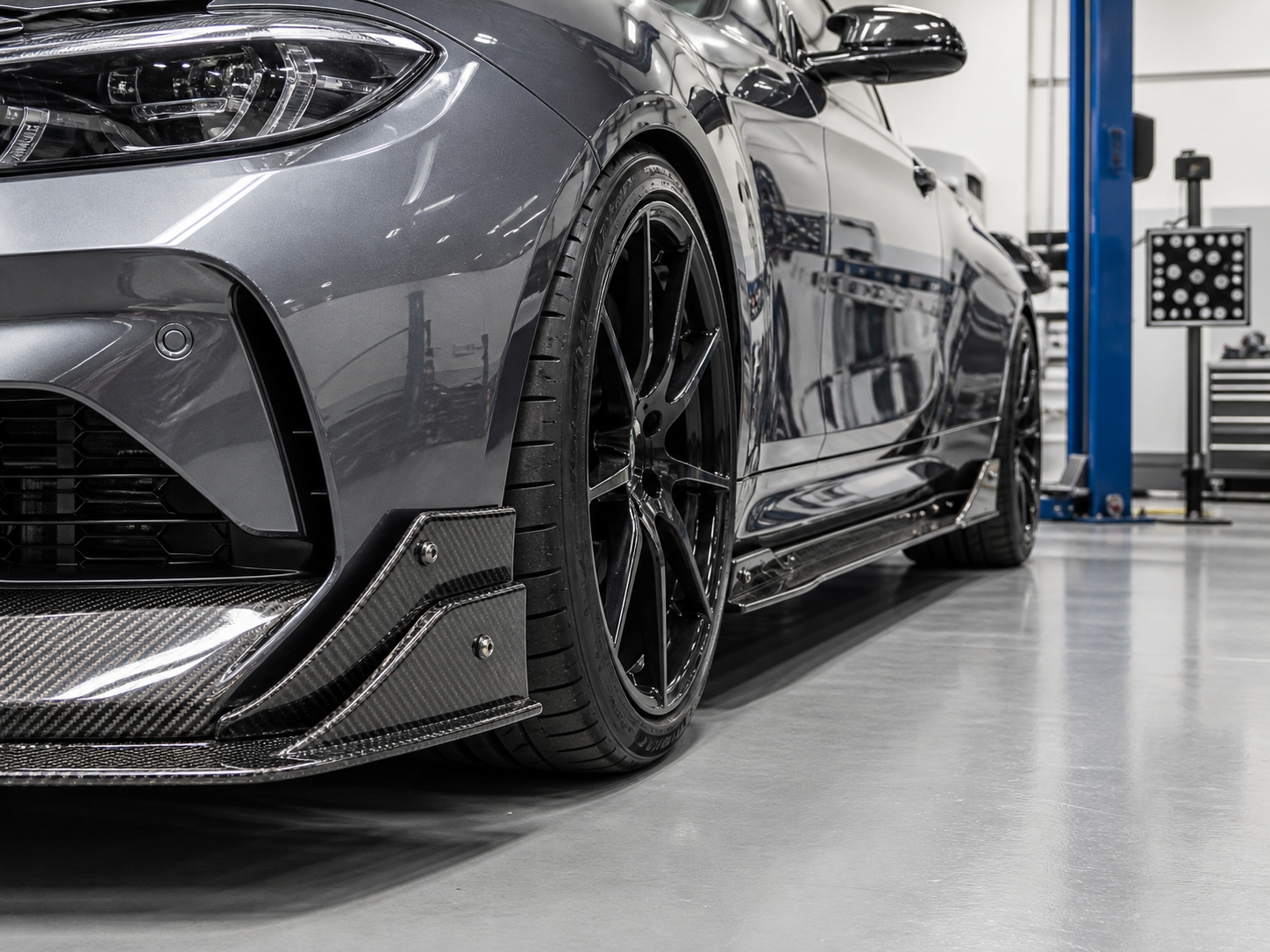 Carbon fiber front splitter and side skirt checked during vehicle fitment