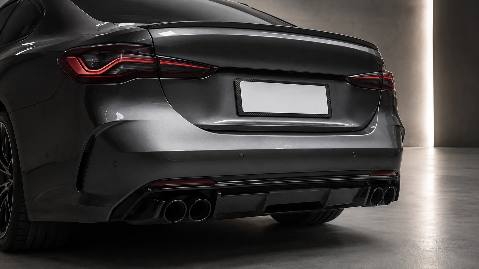 Slim carbon fiber license plate frame installed on a dark performance coupe