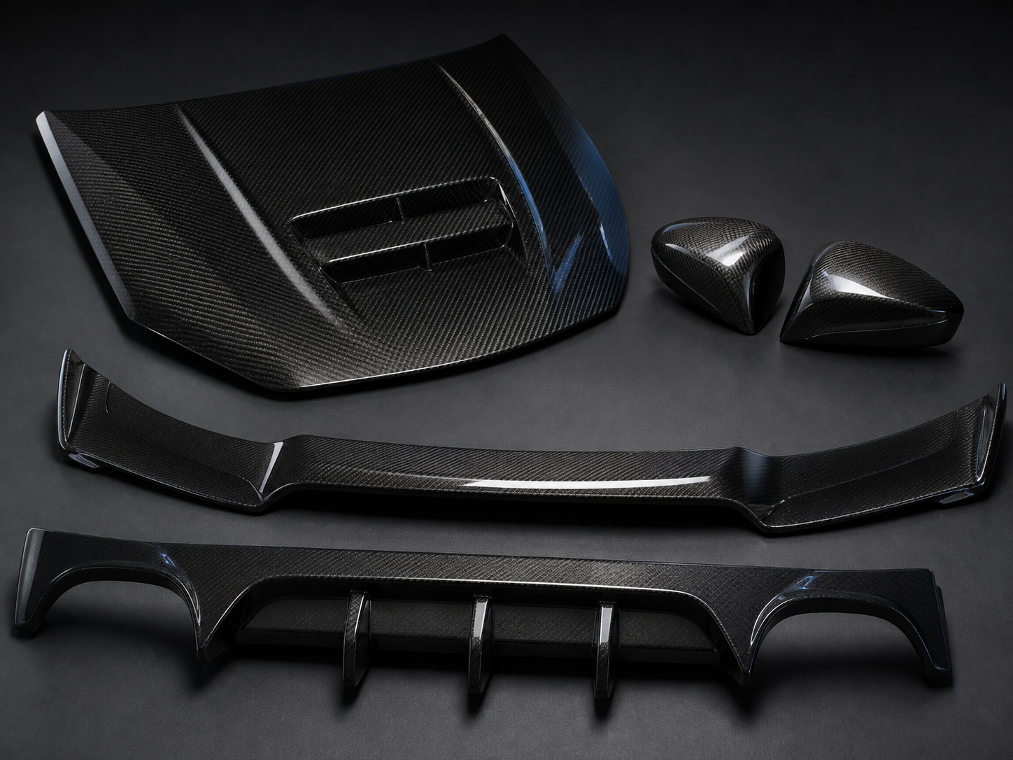 Carbon fiber hood vent front lip side mirror caps and diffuser displayed together
