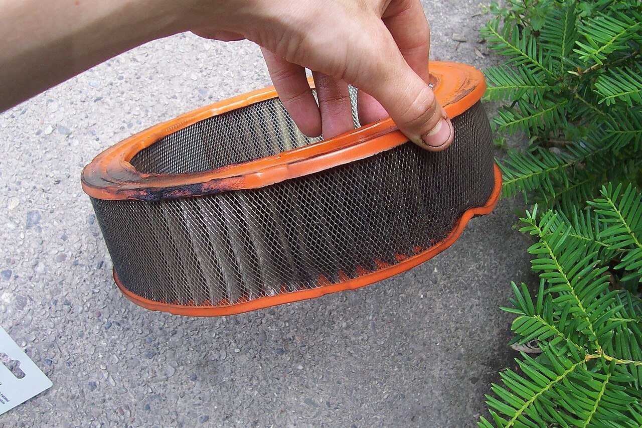 Real photograph of a heavily used dirty automobile engine air filter