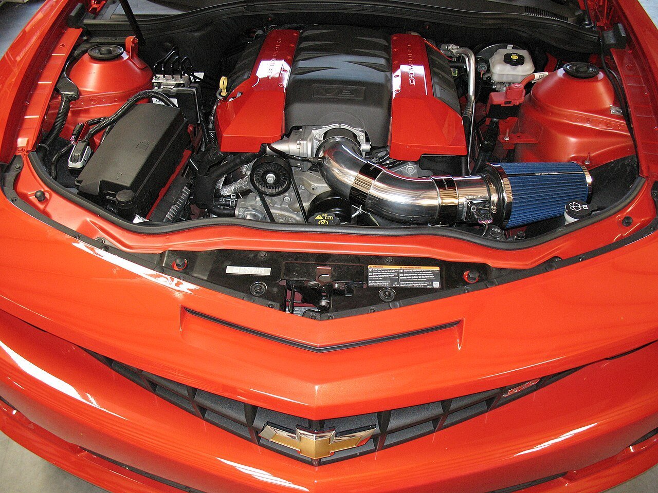 Real photograph of an aftermarket cold air intake installed in an engine bay