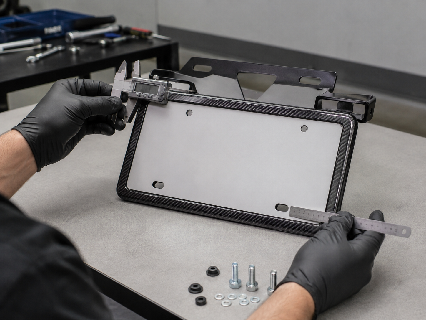 Technician measuring a carbon fiber license plate frame and mounting bracket