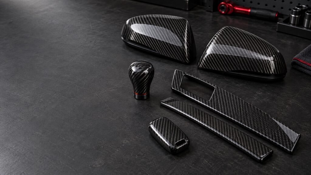 Real carbon fiber car accessories arranged on a premium workshop bench