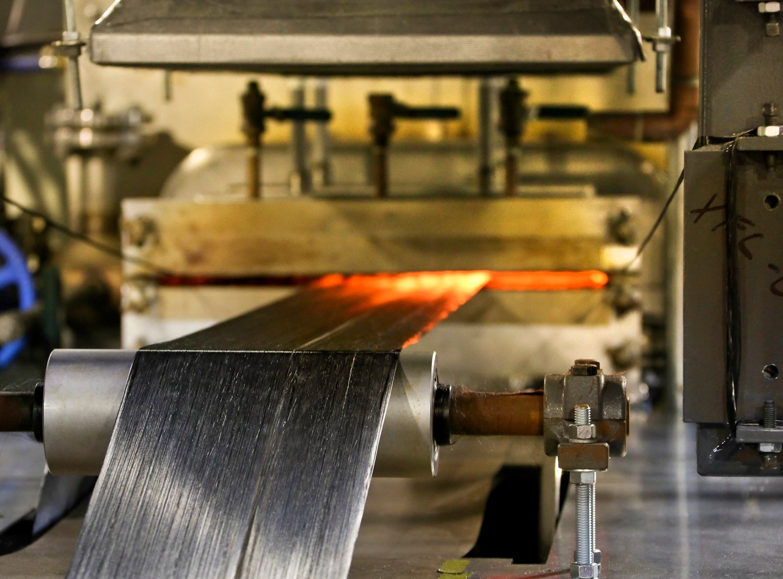 Carbon fiber material moving through production equipment at Oak Ridge National Laboratory — industry reference photograph