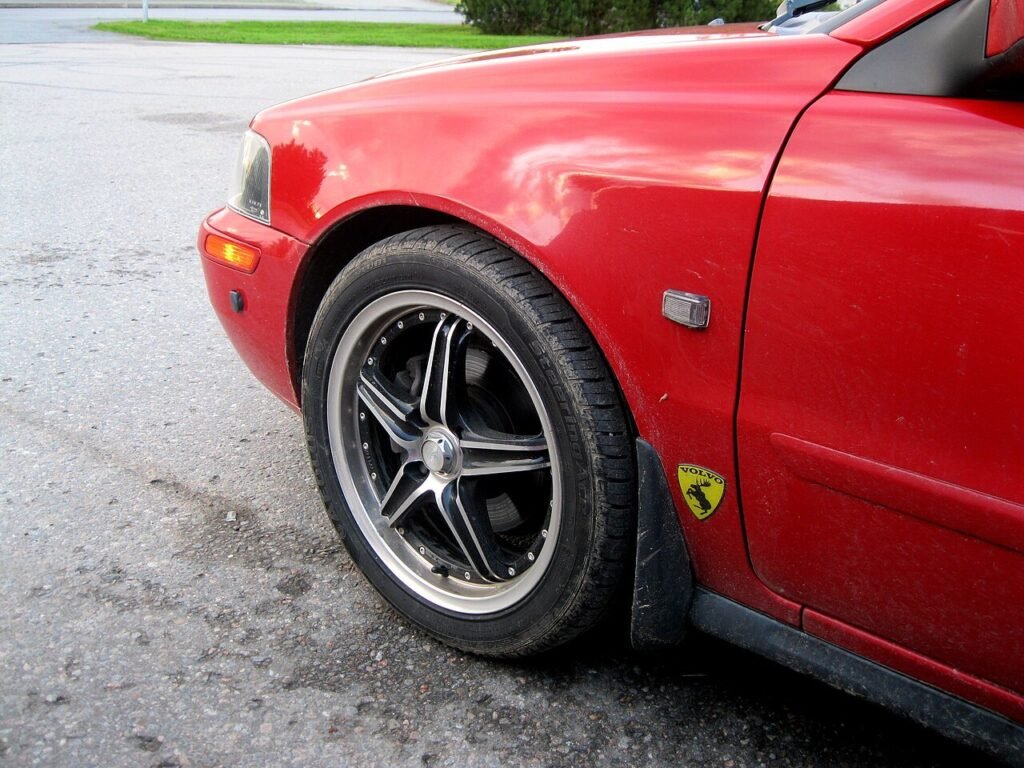 Real close-up photograph of an alloy wheel on a red Volvo S40