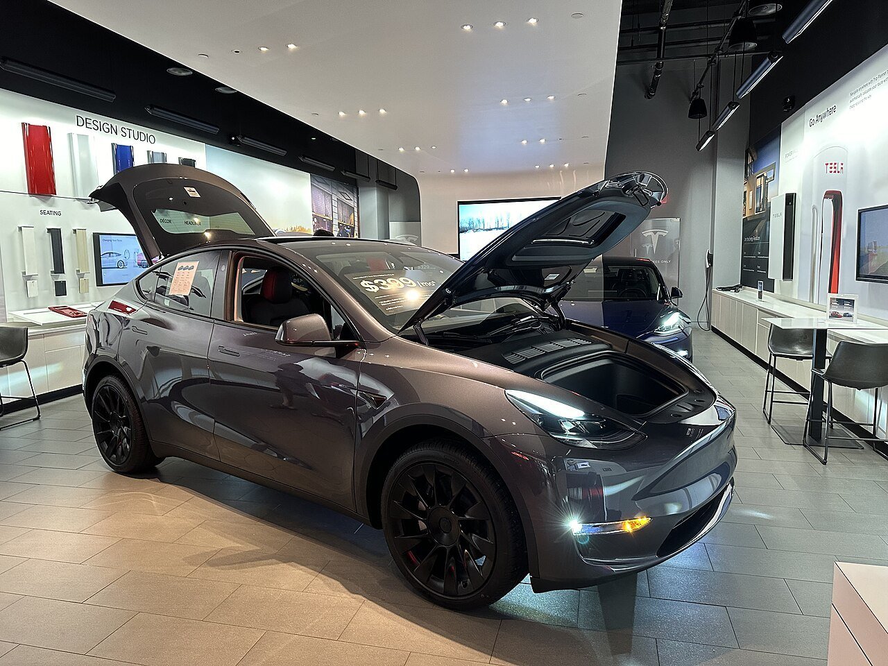 Real photograph of a Tesla showroom car with the trunk lid fully open