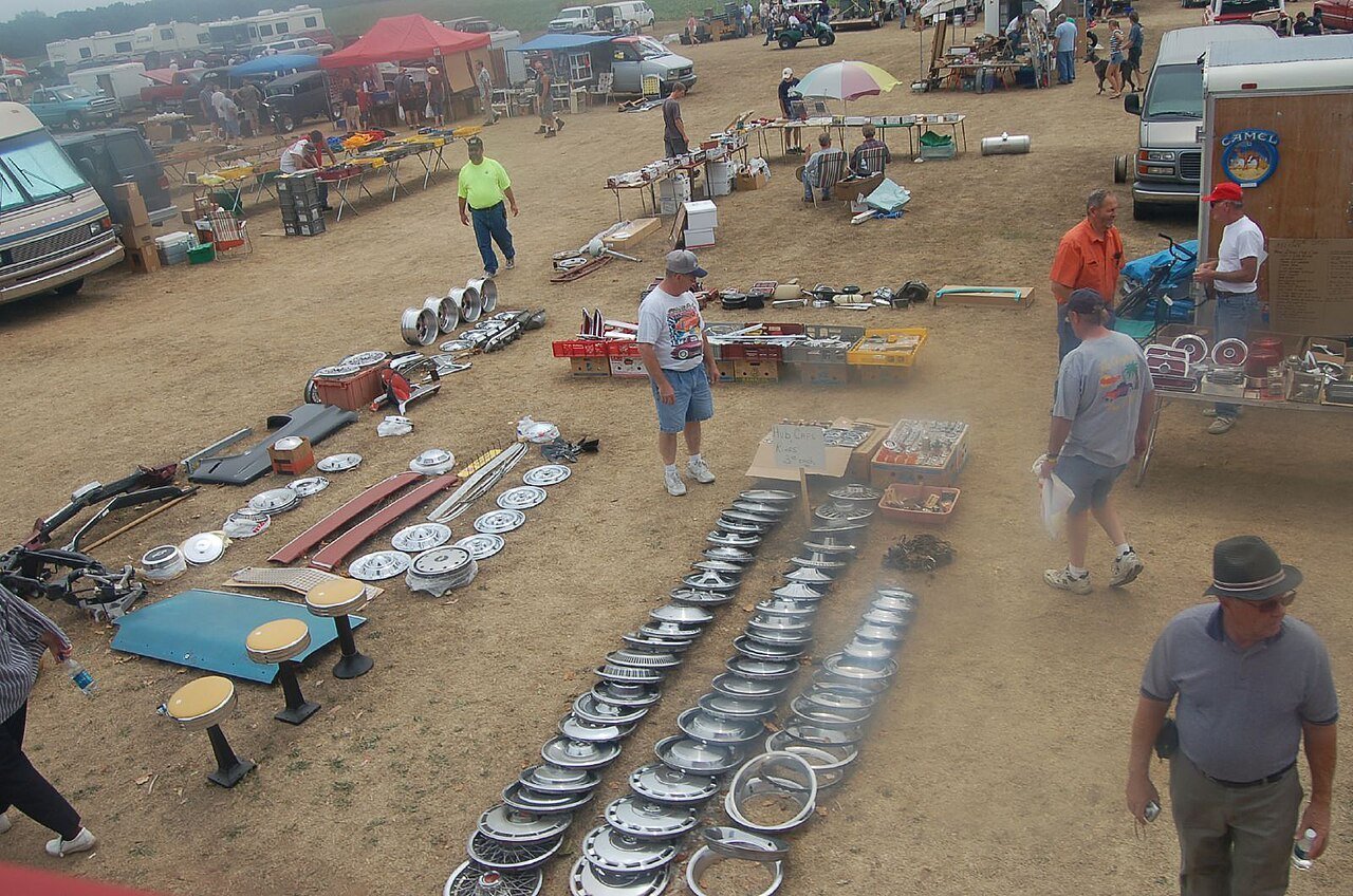 Real photograph of assorted wheel hubcaps and wheel rings for sale