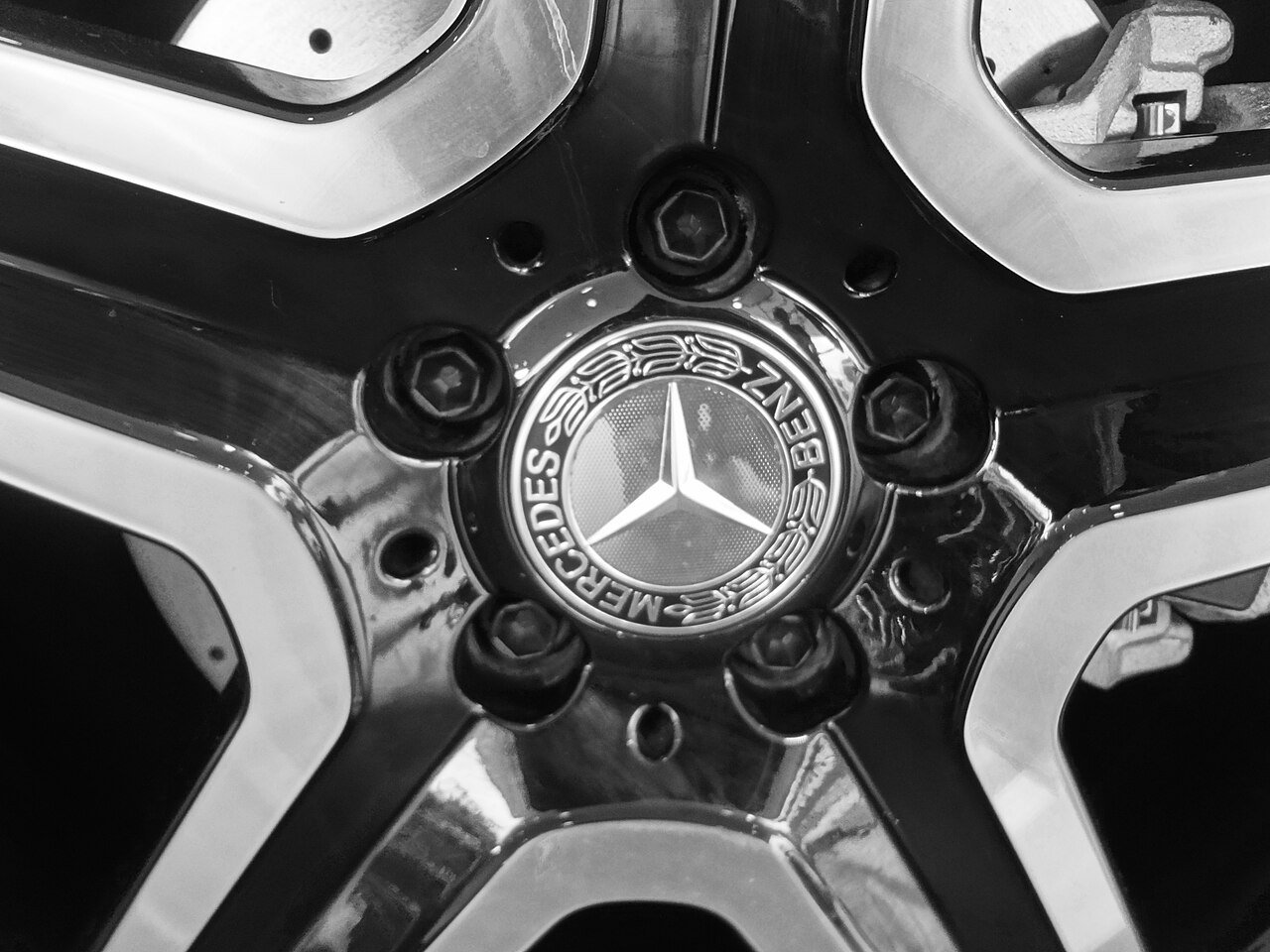 Real monochrome photograph of a Mercedes-Benz wheel and center badge