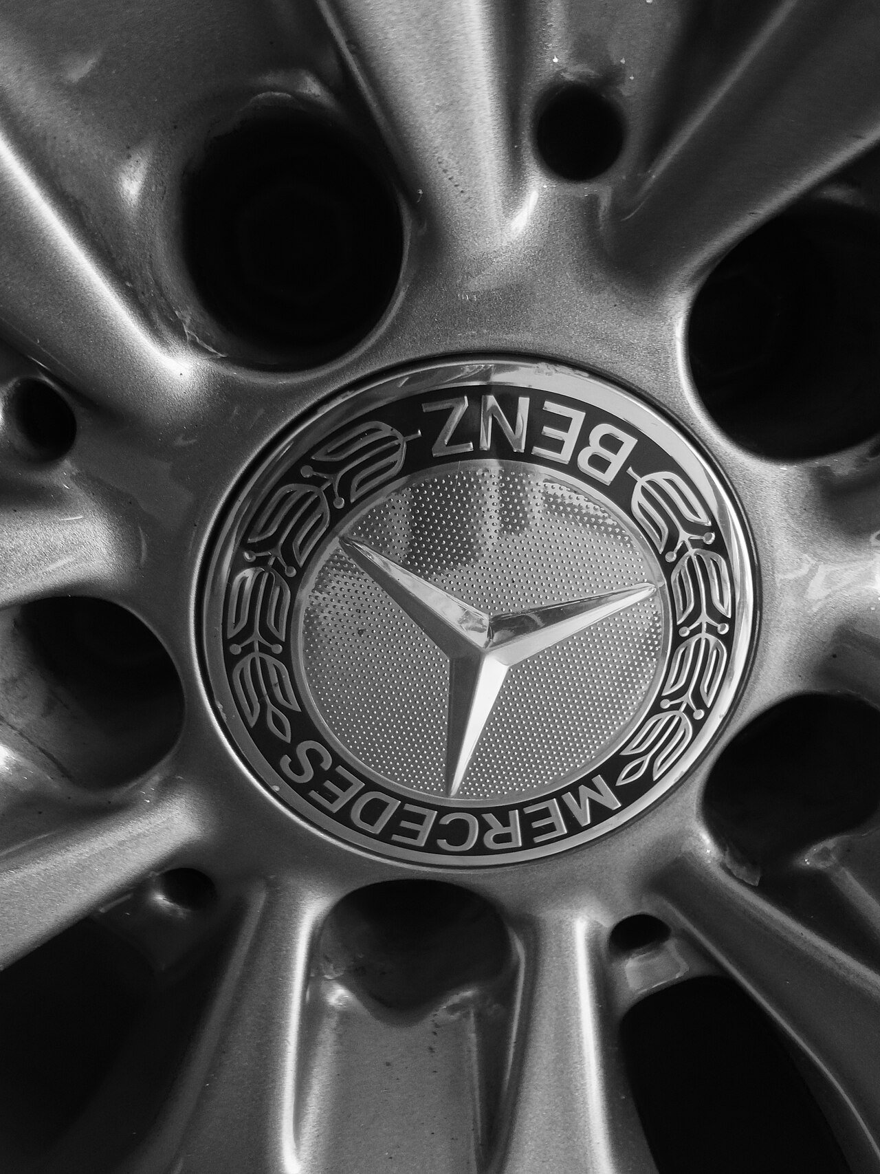 Real monochrome close-up photograph of a Mercedes-Benz alloy wheel