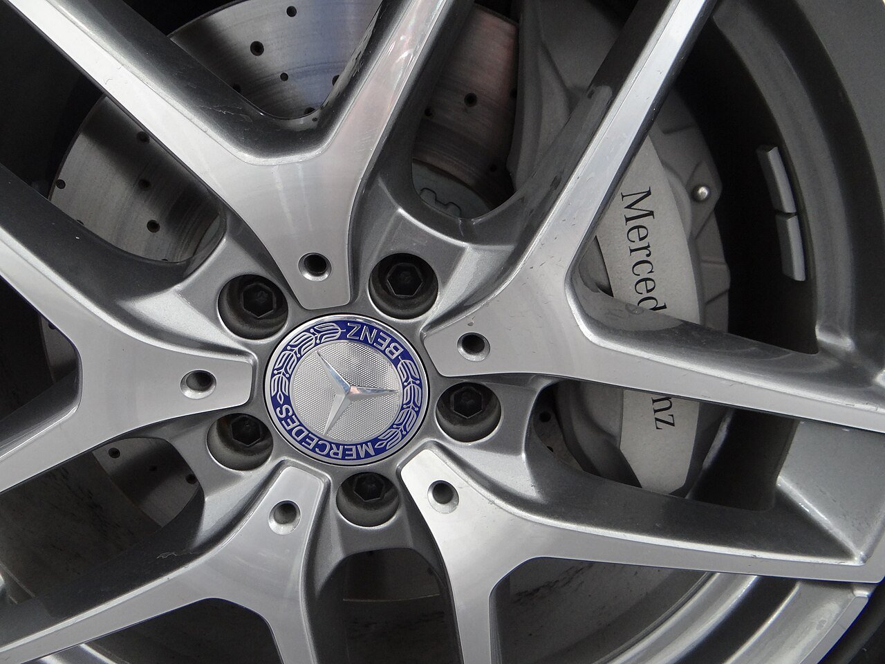 Real photograph of a Mercedes-Benz alloy rim with a center emblem