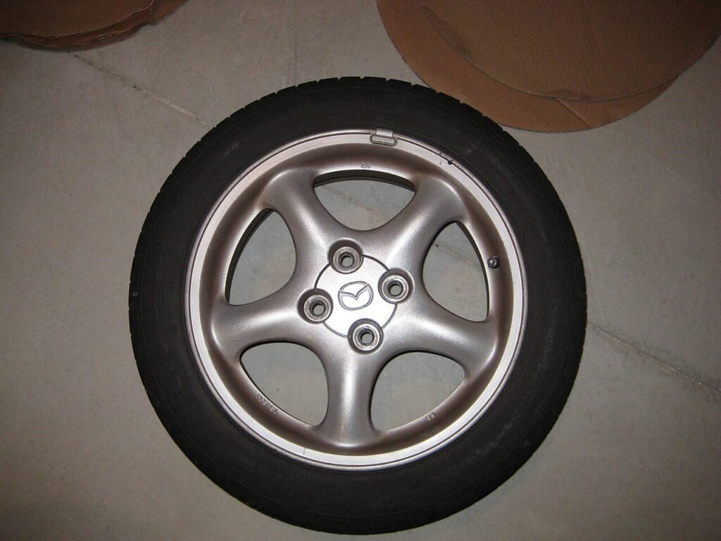 Real close-up photograph of a center cap in an alloy wheel