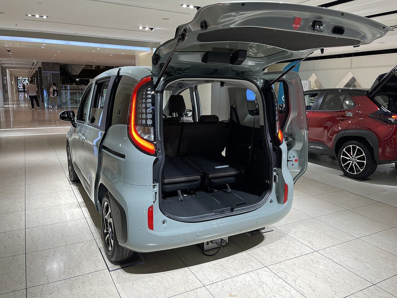 Real rear-view photograph of a Toyota Sienta with its trunk open