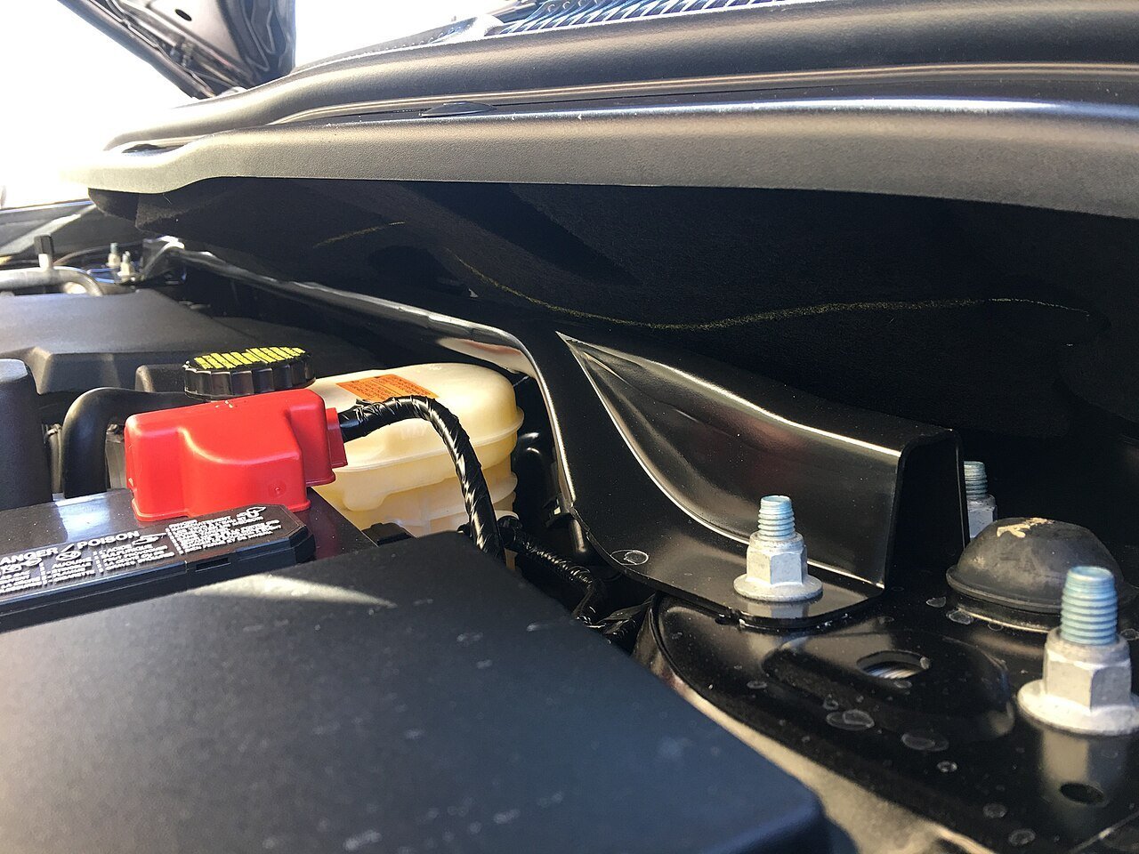 Real photograph of a strut bar installed in an SUV engine bay