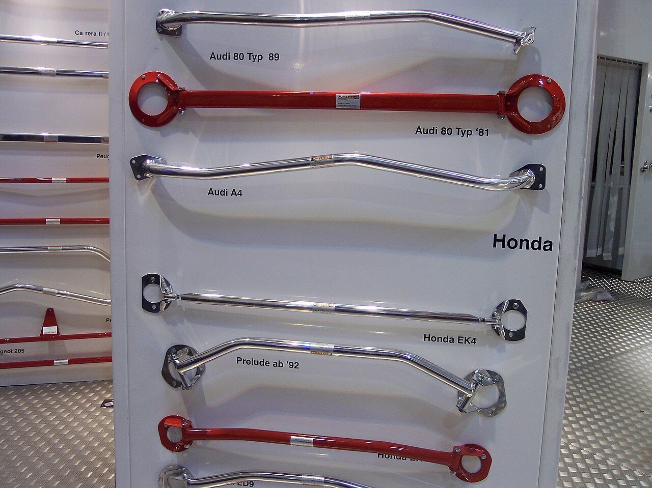 Real photograph of several metal automotive strut braces